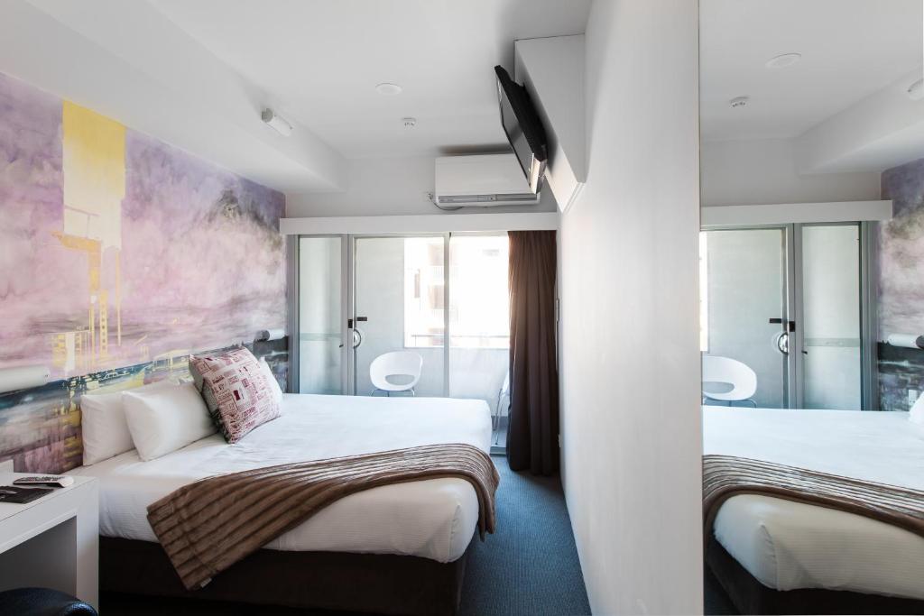 Postel nebo postele na pokoji v ubytování Majestic Minima Hotel