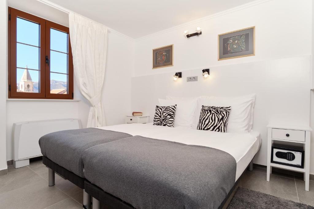Postel nebo postele na pokoji v ubytování Apartments Zebra
