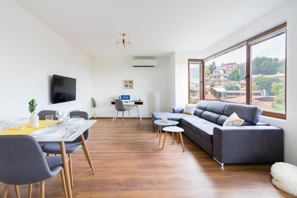 a living room with a couch and a table at Domus Apartments Old Town in Plovdiv