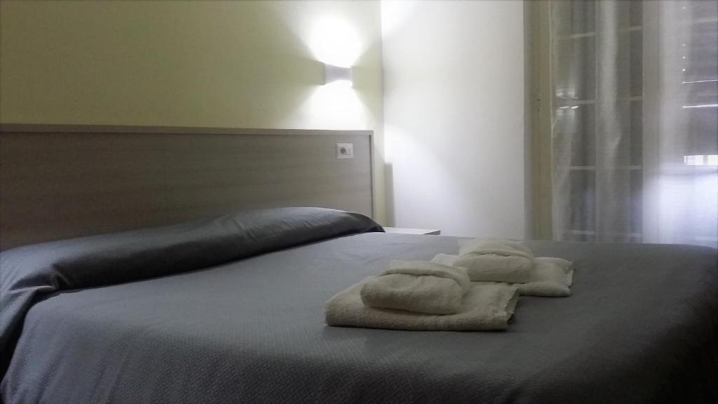 Postel nebo postele na pokoji v ubytování Guesthouse Holiday Formia beach