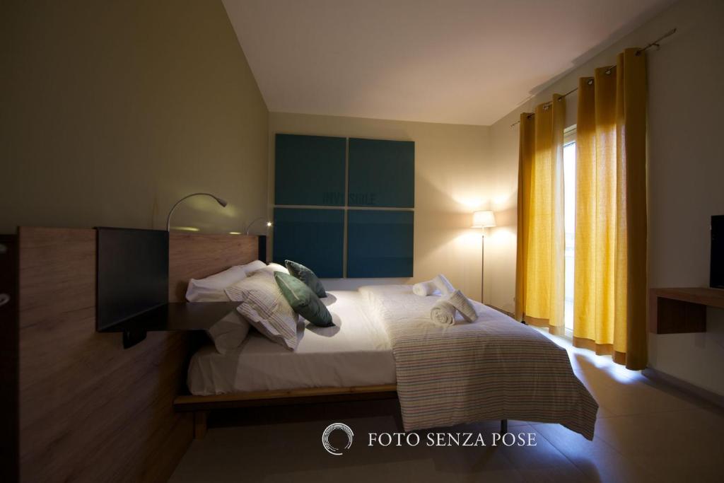 A bed or beds in a room at lepini suites affittacamere
