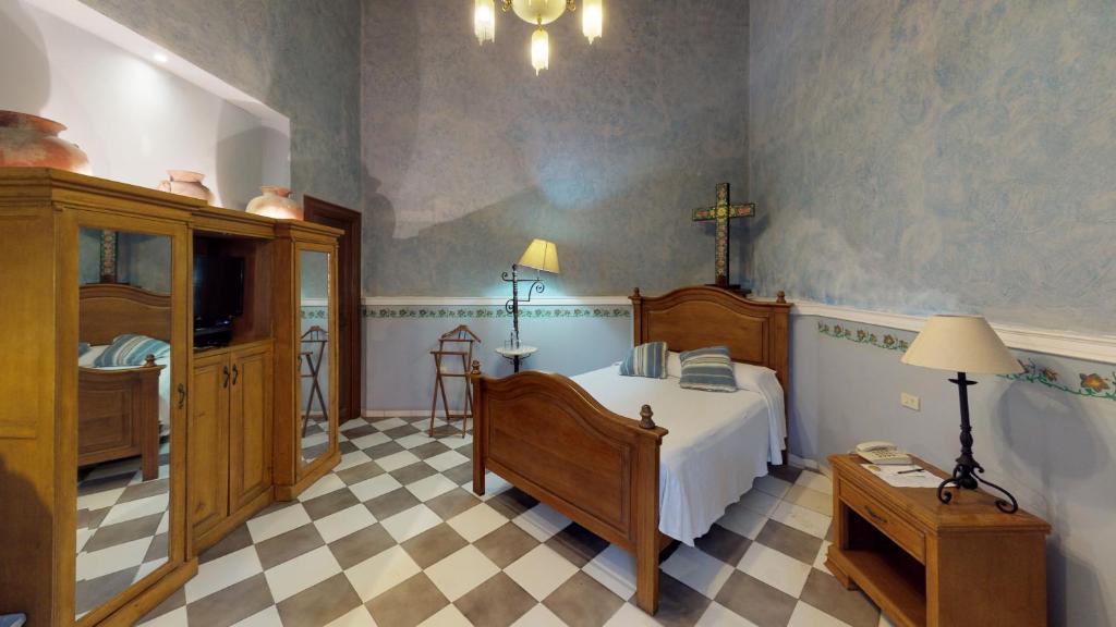 Postel nebo postele na pokoji v ubytování Hotel Boutique La Mision De Fray Diego