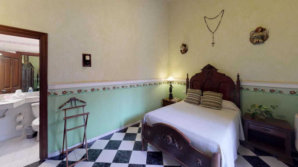 Postel nebo postele na pokoji v ubytování Hotel Boutique La Mision De Fray Diego