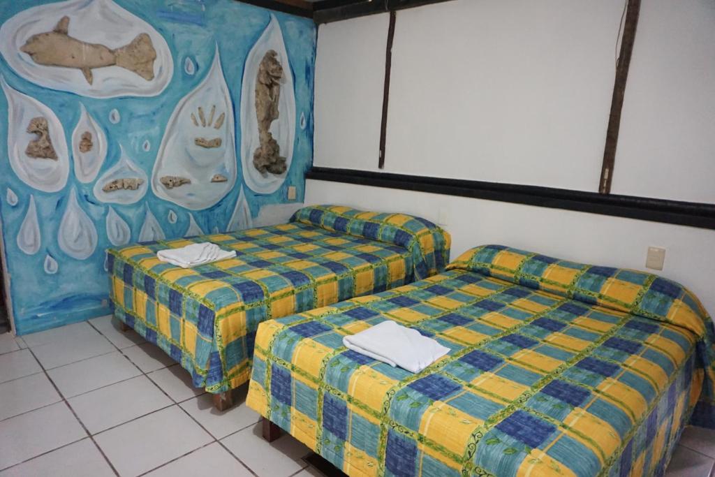 Postel nebo postele na pokoji v ubytování Hotel Cabañas Safari