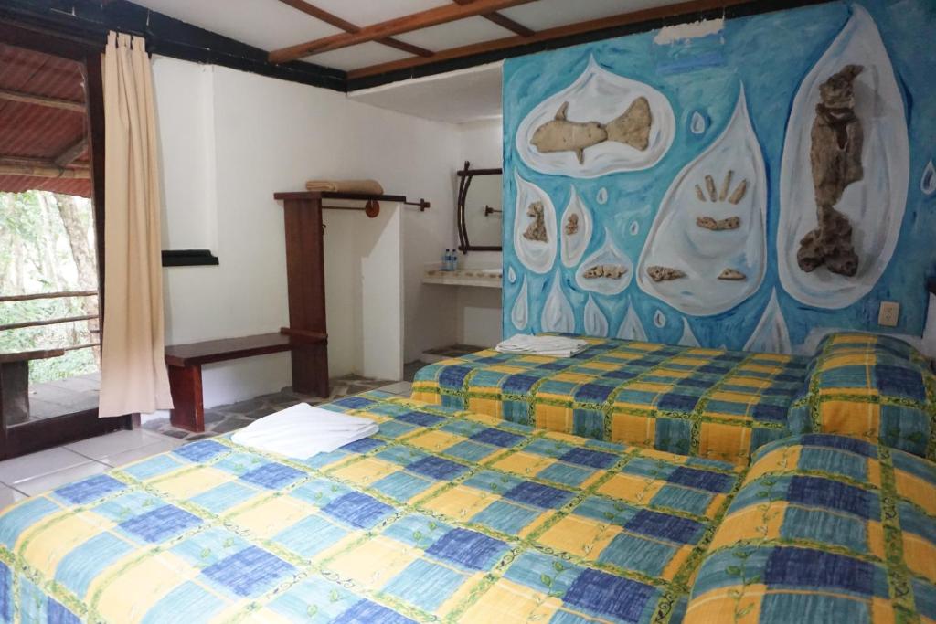 Postel nebo postele na pokoji v ubytování Hotel Cabañas Safari