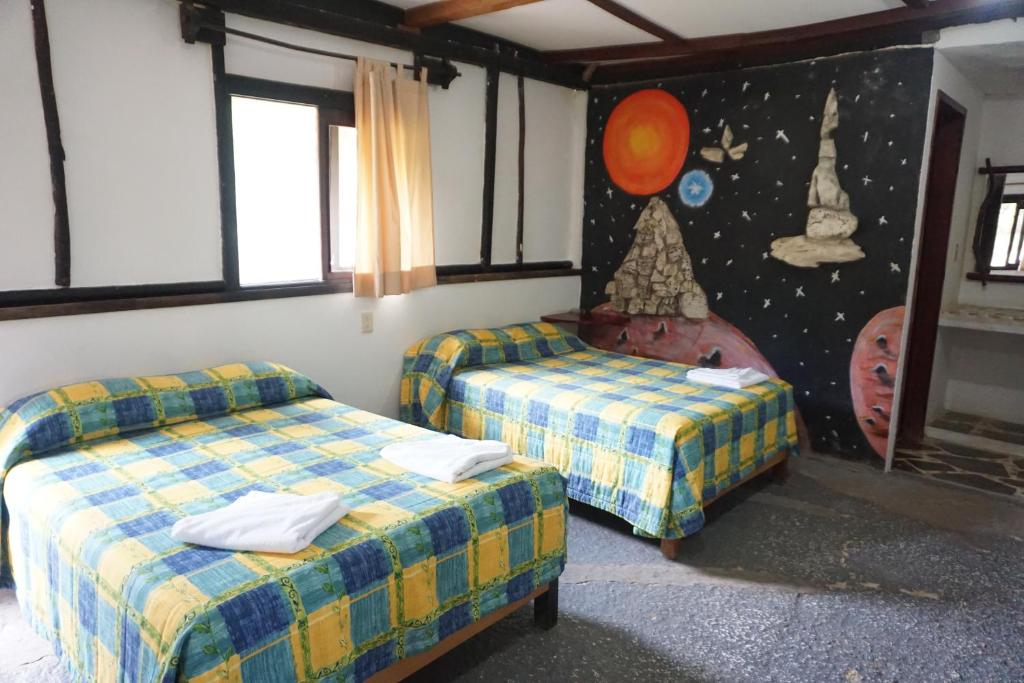 Postel nebo postele na pokoji v ubytování Hotel Cabañas Safari