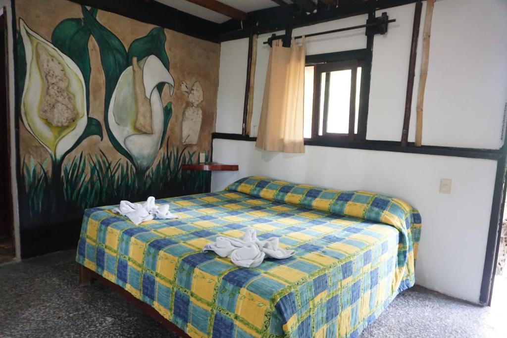 Postel nebo postele na pokoji v ubytování Hotel Cabañas Safari