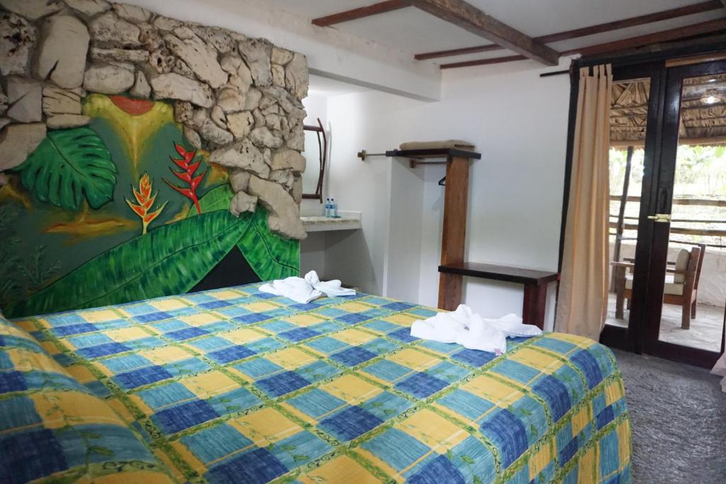 Postel nebo postele na pokoji v ubytování Hotel Cabañas Safari