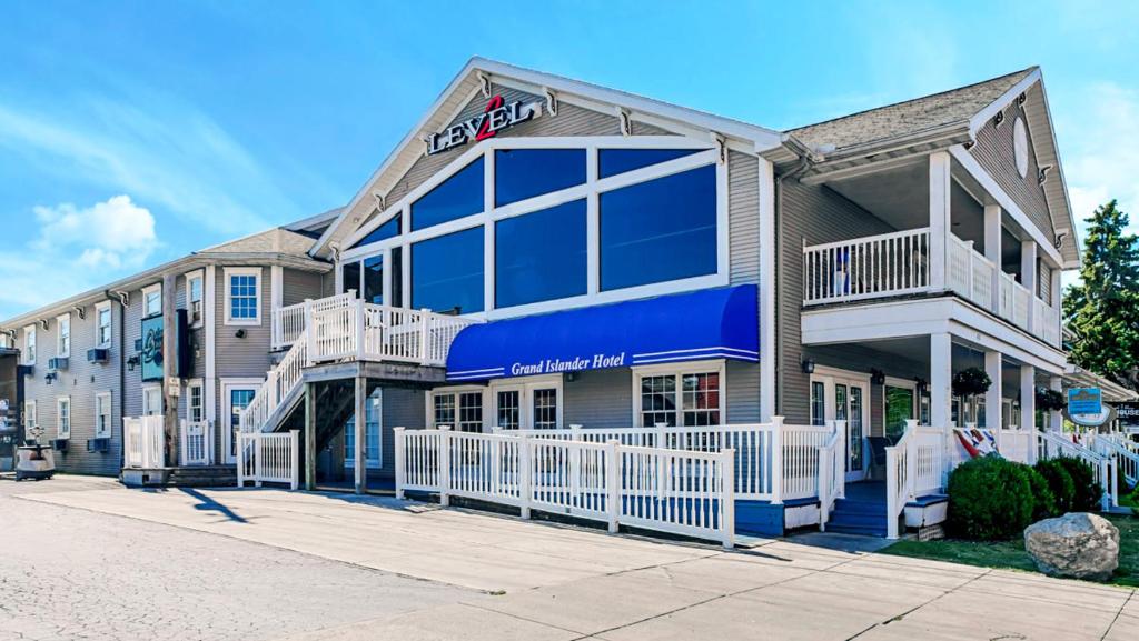 a large building with a blue sign on it at Grand Islander Hotel in Put-in-Bay