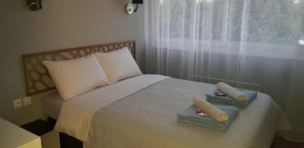 a bedroom with a bed with two towels on it at Palm beach Cannes Azur in Cannes