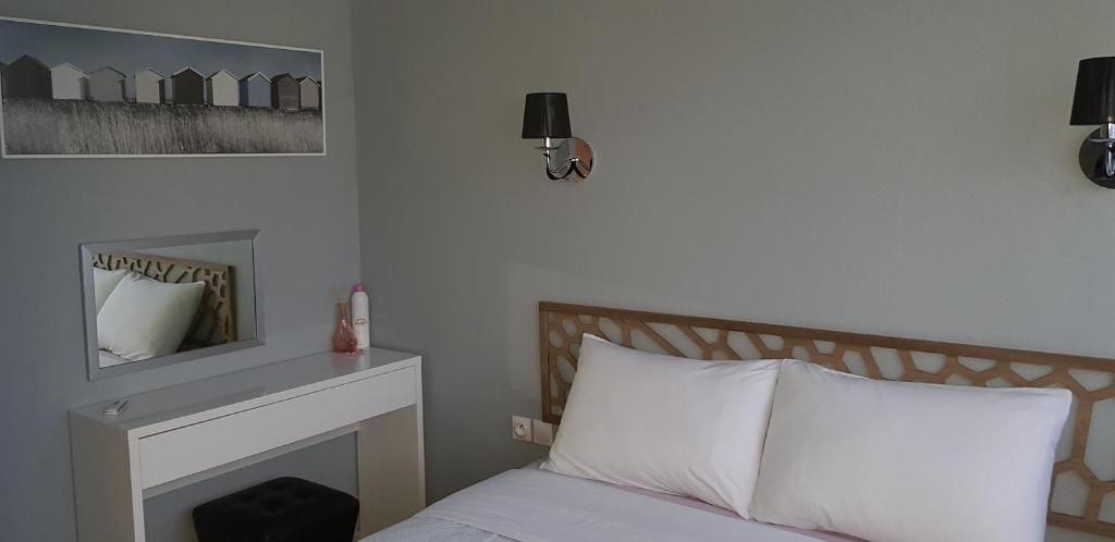 a bedroom with a bed with a fireplace and a mirror at Palm beach Cannes Azur in Cannes