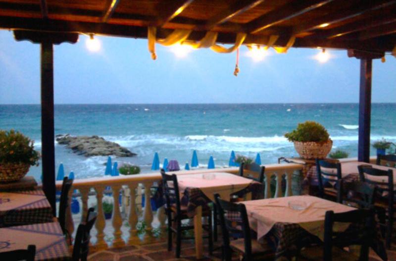 a view of the ocean from a restaurant with tables and chairs at Delfini in Kallithea Halkidikis