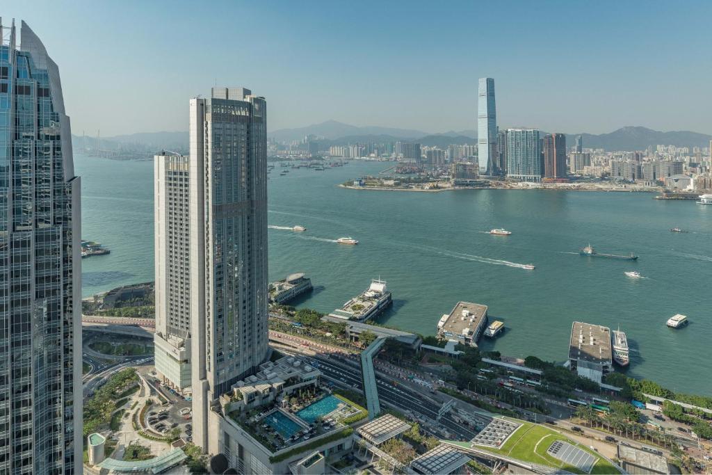 a view of a city with a river and buildings at Four Seasons Hotel Hong Kong in Hong Kong