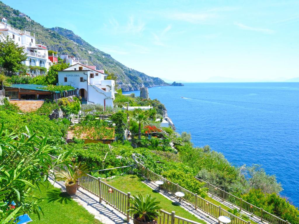 a town on a hill next to the ocean at Hotel Costa Diva in Praiano