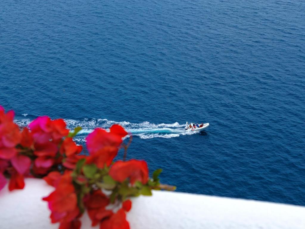 a boat in the water with a group of people on it at Hotel Costa Diva in Praiano