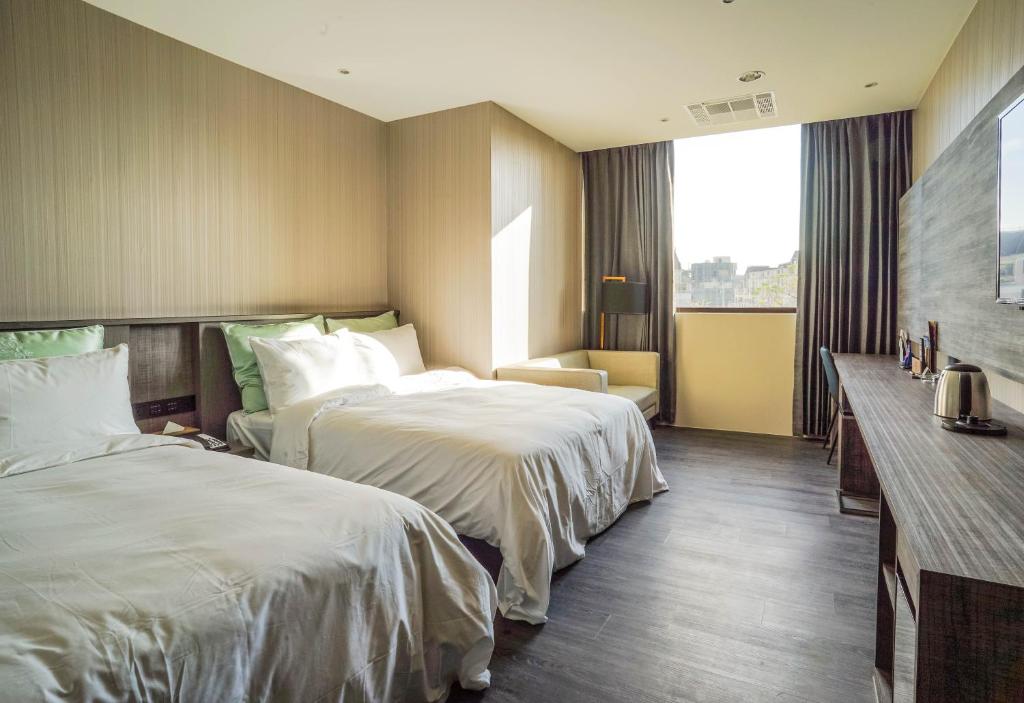 Postel nebo postele na pokoji v ubytování Shu Xin Motel