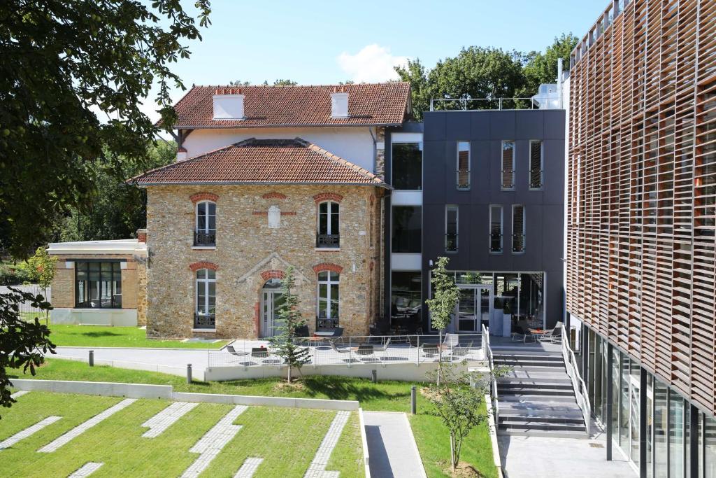 an external view of a building between two buildings at Best Western Plus Paris Meudon Ermitage in Meudon