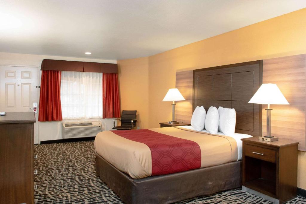 a hotel room with a bed and a window at Executive Inn westley,CA in Westley