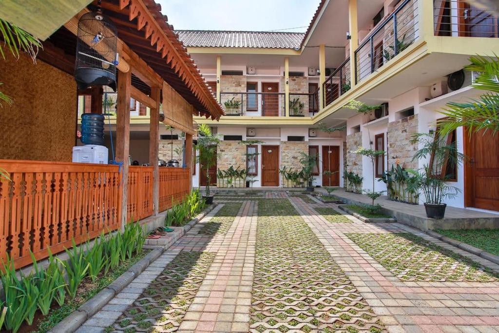 a courtyard of a house with a walkway at Sandy's Homestay in Banyuwangi