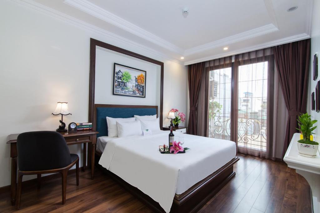Postel nebo postele na pokoji v ubytování Hanoi Central Hotel & Residences