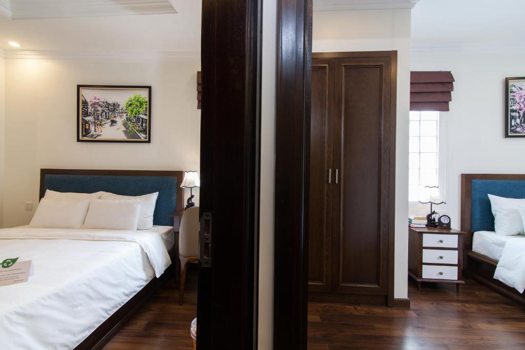 Postel nebo postele na pokoji v ubytování Hanoi Central Hotel & Residences