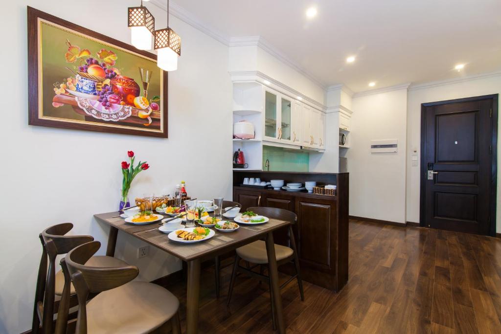 a dining room with a table with food on it at Hanoi Central Hotel & Residences in Hanoi