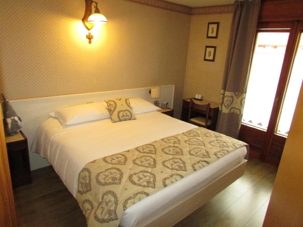 Postel nebo postele na pokoji v ubytování Hotel Meublè Meridiana
