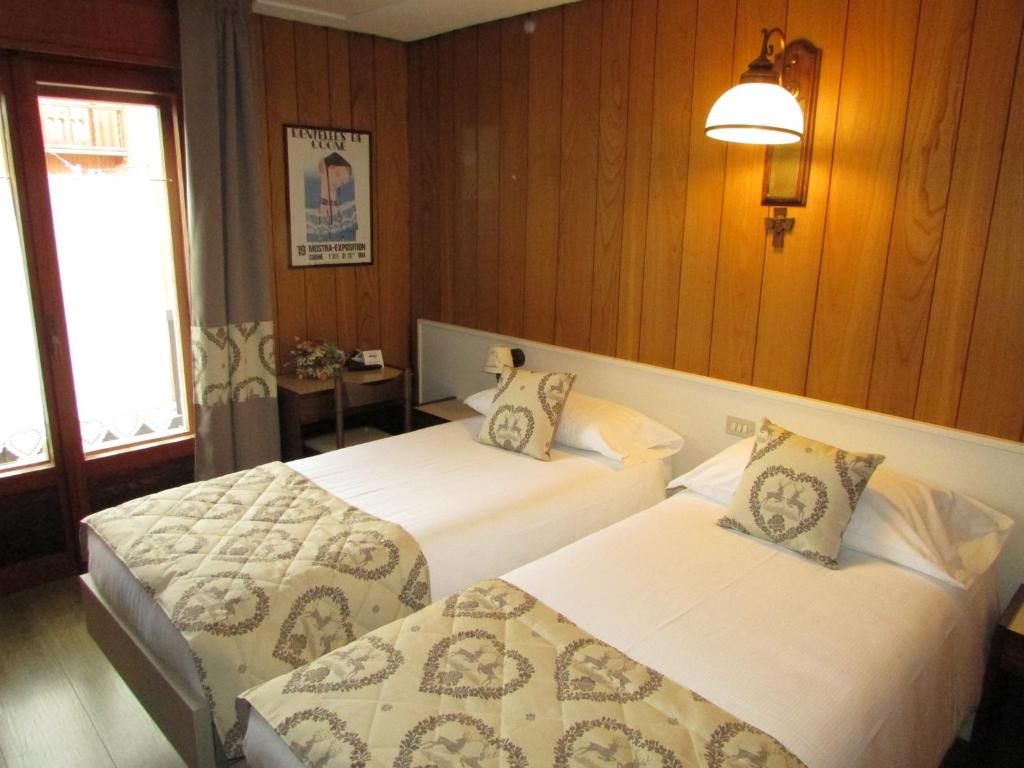 Posteľ alebo postele v izbe v ubytovaní Hotel Meublè Meridiana