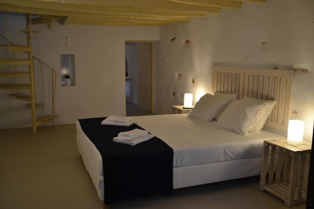 a bedroom with a bed with two towels on it at Kastro in Parikia