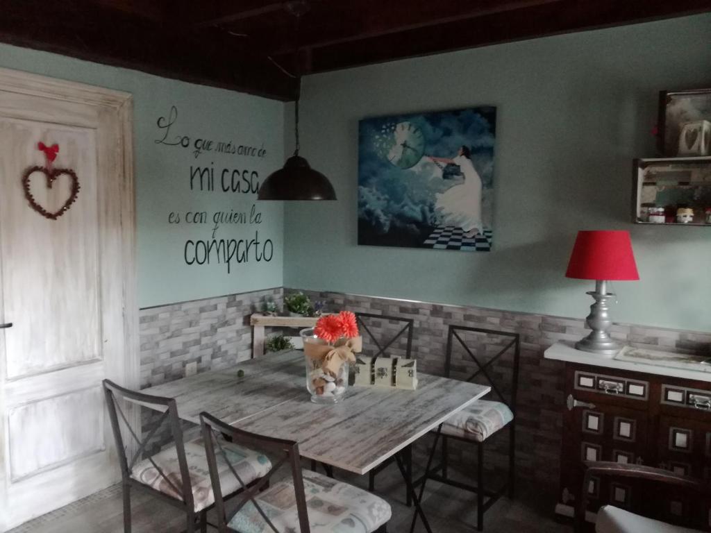 a dining room with a wooden table and chairs at Villa castellanos in Isla