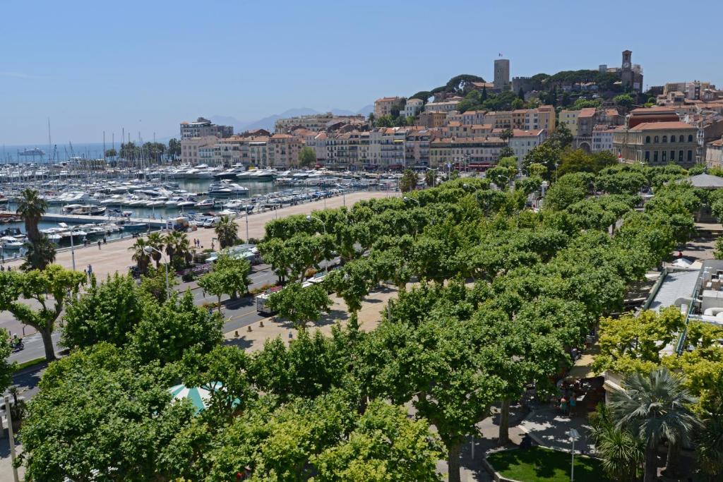 a city with a marina and a bunch of trees at Hotel Splendid in Cannes
