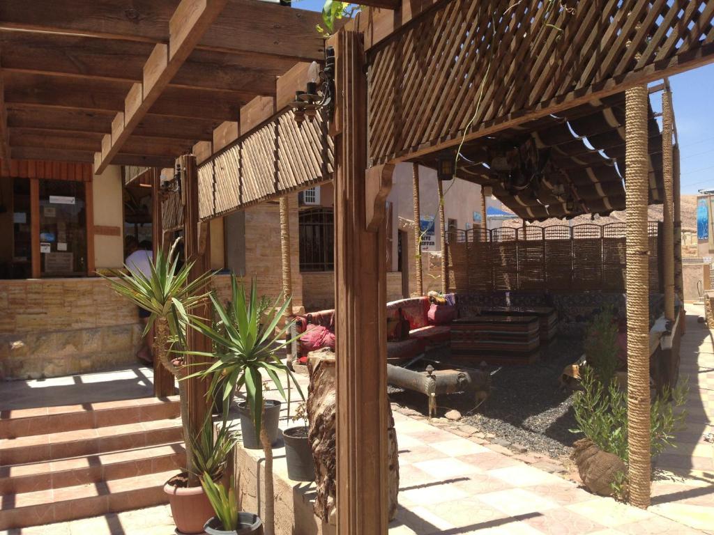 two people sitting on a porch of a house at Arab Divers Dive Center and Bed & Breakfast in Aqaba