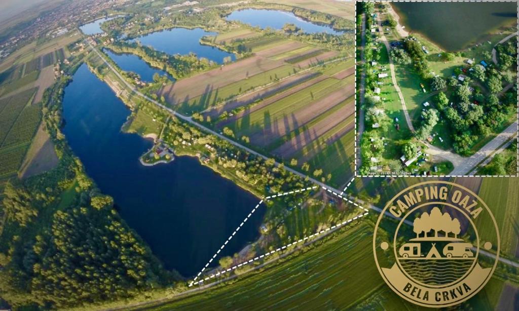 an aerial view of a lake with a bridge at Camping Oaza in Bela Crkva