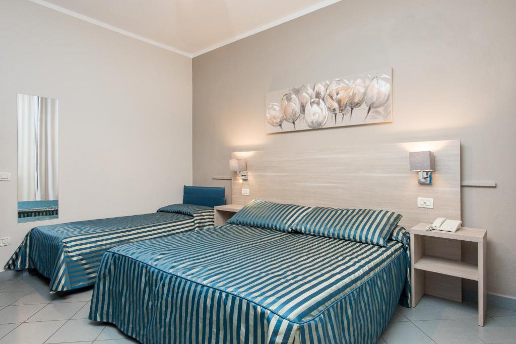 Postel nebo postele na pokoji v ubytování HG Hotel Il Settebello