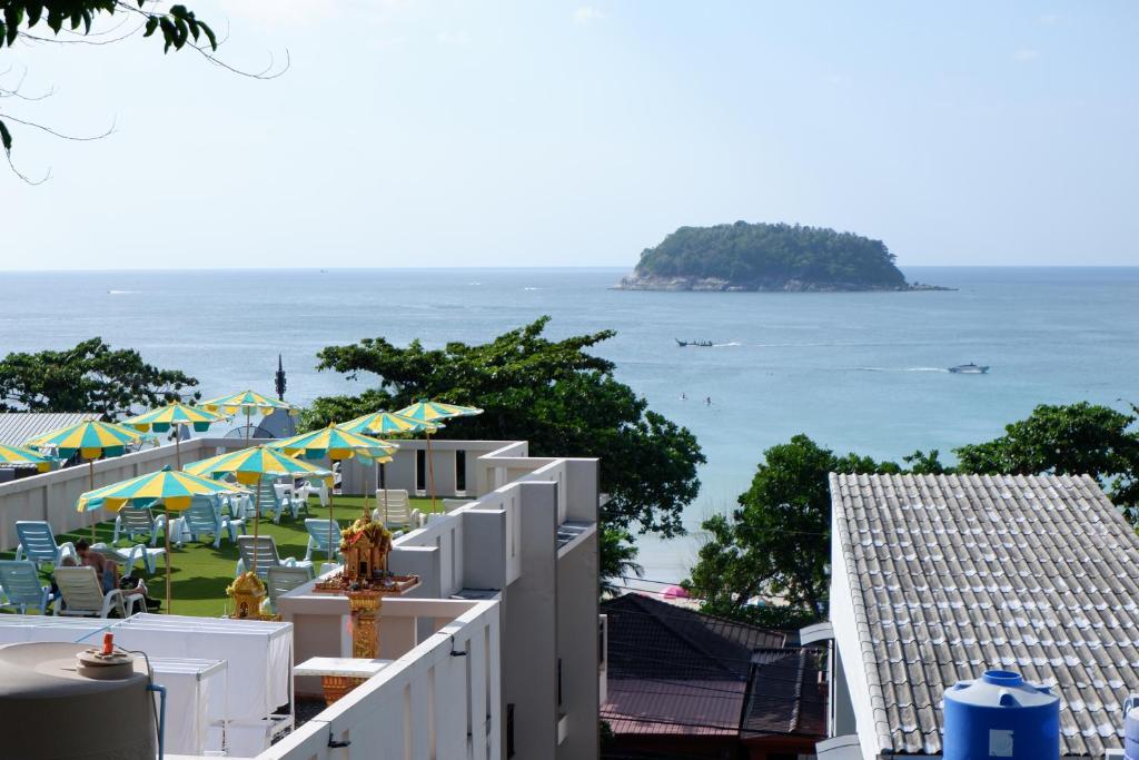 a view of the ocean from the balcony of a resort at Kata Beachwalk Hotel and Bungalows in Kata Beach