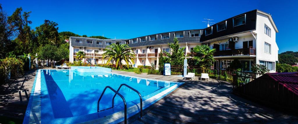 a large swimming pool in front of a building at WaterLoo Hotel in Loo