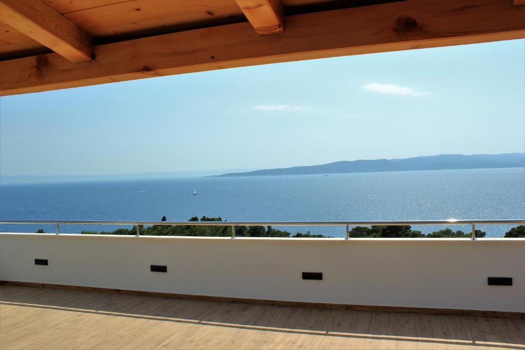 a view from the balcony of a house overlooking the ocean at Apartments SKY in Brela