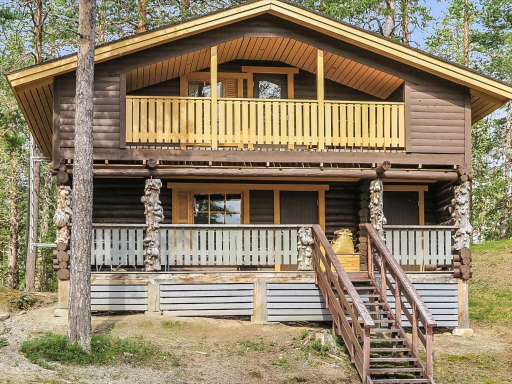 a large log cabin with a porch and a deck at Holiday Home Ruska by Interhome in Kyrö