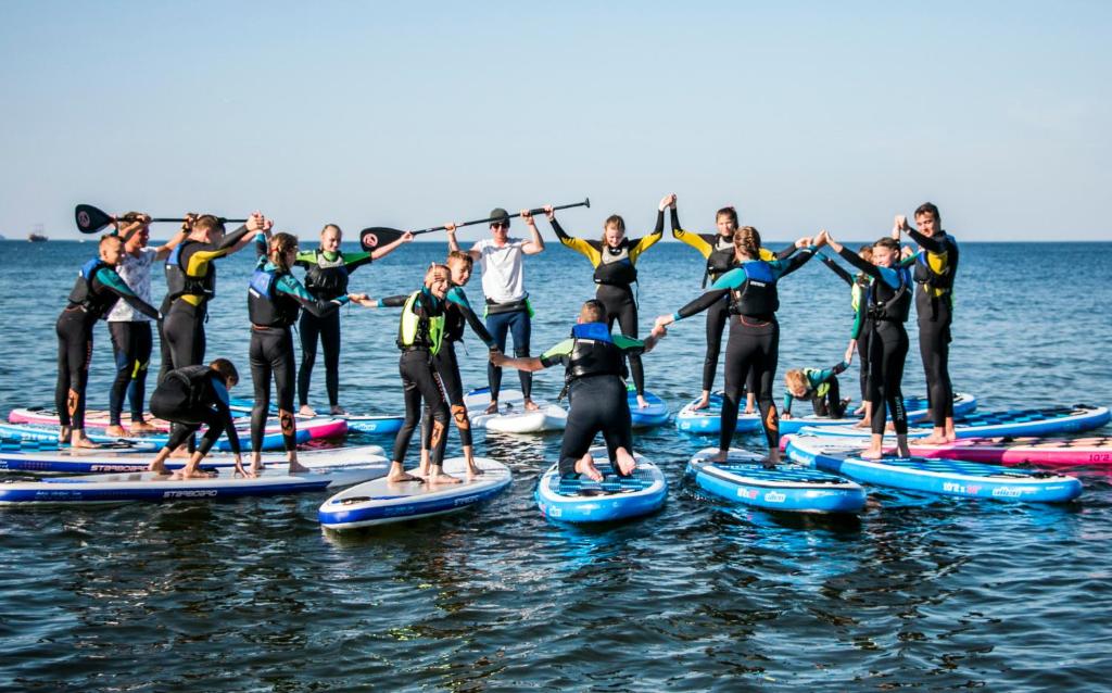 a group of people on paddle boards in the water at Sopot 34 przy plaży in Sopot