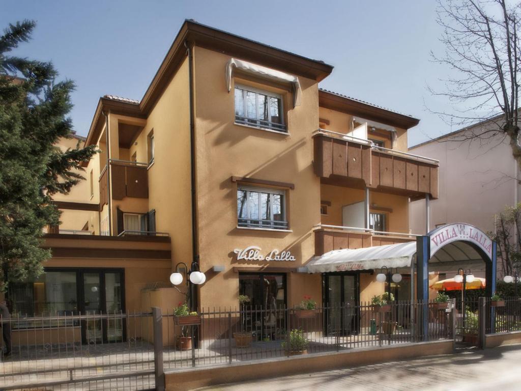 a large building with a sign in front of it at Hotel Villa Lalla in Rimini