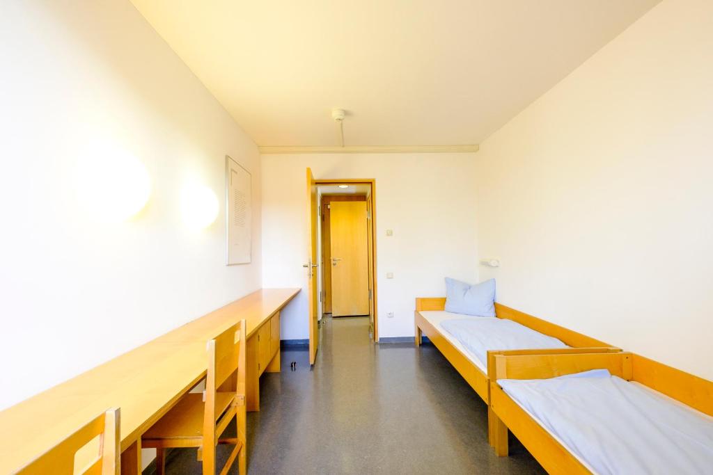 Postel nebo postele na pokoji v ubytování Internationales Jugendgästehaus Dachau