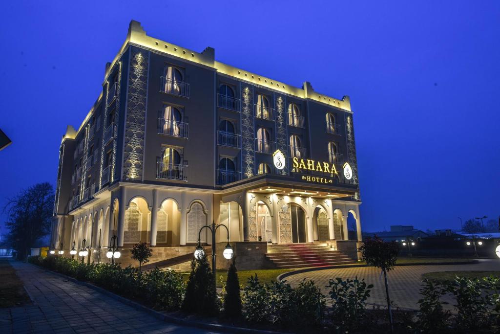 a large building is lit up at night at Sahara Hotel in Svilengrad