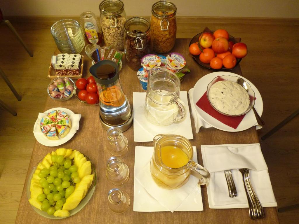 a wooden table with food and fruit on it at Cafe und Pension Blohm in Greifswald