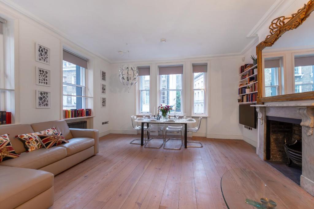 a living room with a couch and a table at Museum View in London