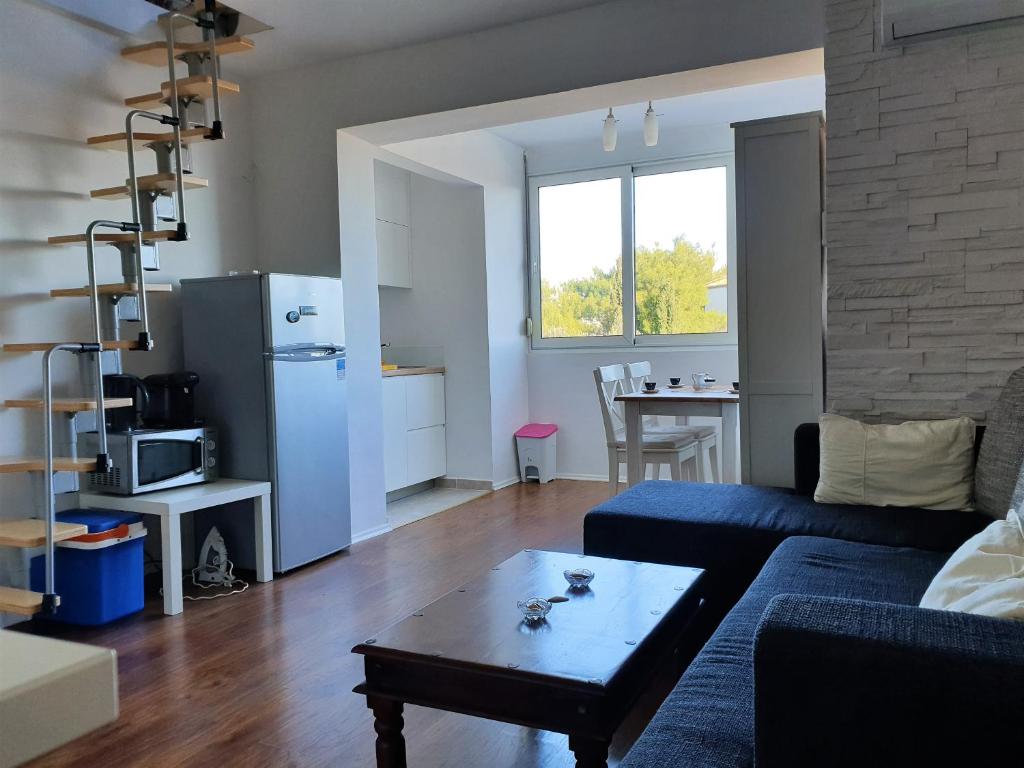 a living room with a couch and a table at Apartment IVANA in Novalja