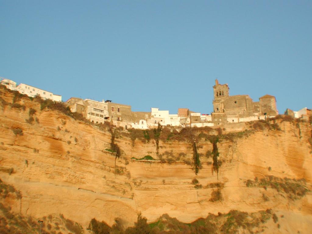 a group of buildings on the side of a cliff at Casa Maldonado in Arcos de la Frontera