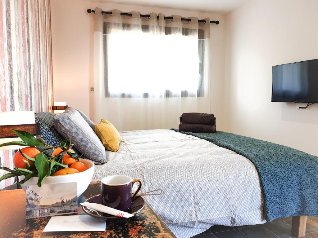 a bedroom with a bed with a bowl of fruit on a table at Casa Petre e Fiori in Cervione