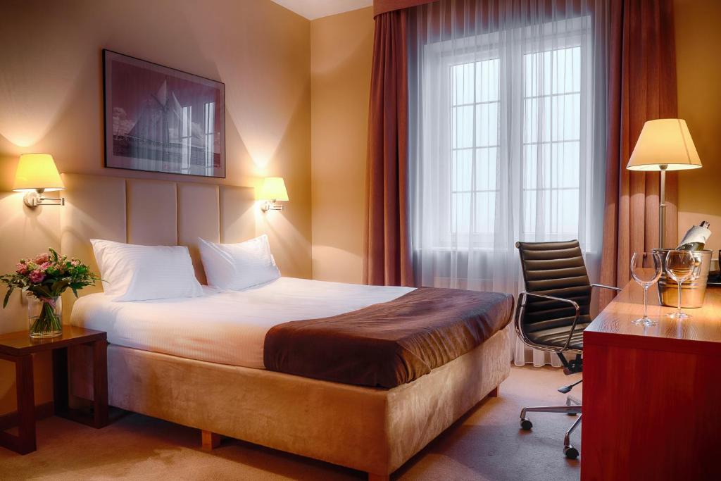En eller flere senge i et værelse på Focus Hotel Szczecin