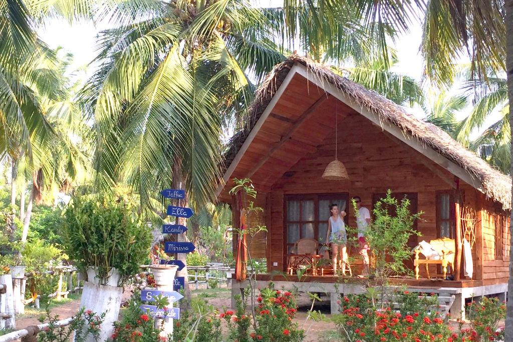 two people standing on the porch of a house at Ruuk Village in Kalpitiya