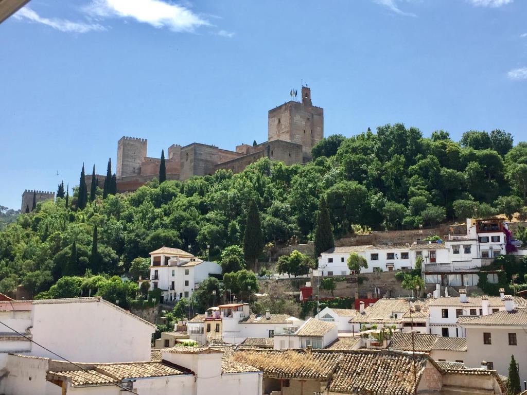 Blick auf eine Stadt mit einem Schloss auf einem Hügel in der Unterkunft Casa Mirador Alhambra in Granada